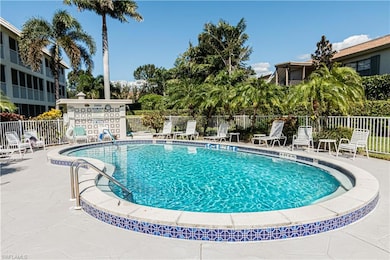 Community pool featuring fence and a patio area