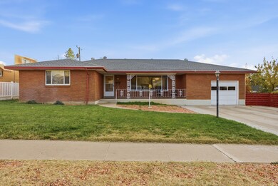 Ranch-style home with brick siding, a shingled roof, a garage, and concrete driveway