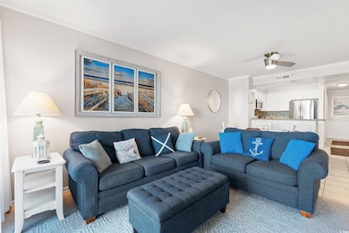 Living area featuring crown molding and a ceiling fan