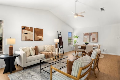 Living room with ceiling fan, high vaulted ceilin
