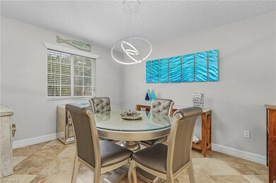Dining room featuring a textured ceiling and a chandelier