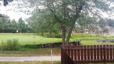 View of golf course and pond. 14 hole directly in 