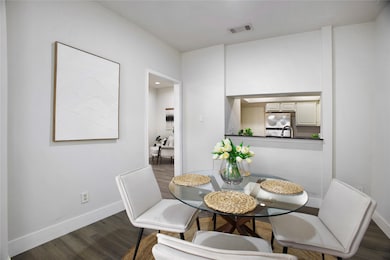 Dining room with dark wood-type flooring