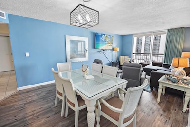 Dining space with a textured ceiling, an inviting 
