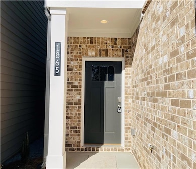 View of exterior entry with brick siding
