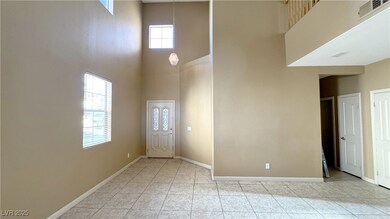 Entrance foyer featuring visible vents, a towering