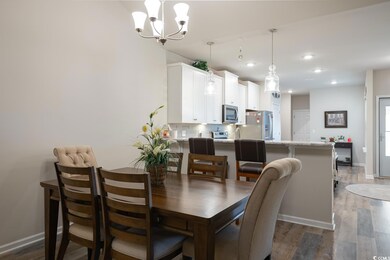 Dining room with dark wood-type flooring and an in
