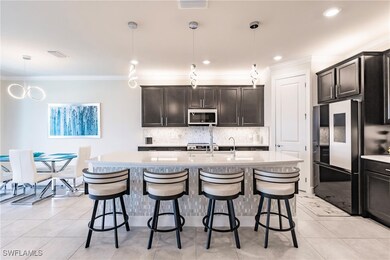 Kitchen with light countertops, black refrigerator