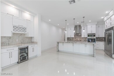 Kitchen featuring white cabinets, visible vents, w