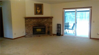 LIVING ROOM: WOOD BURNING FIREPLACE OPENS TO POOL AREA