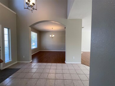 Spare room with a chandelier, arched walkways, an