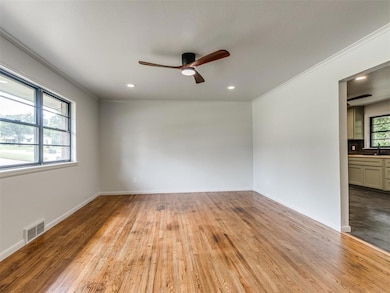Another view showcasing the spacious living room with expansive wall space to utilize but remaining open to the dining area for an excellent flow