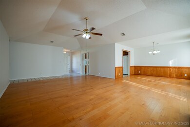 Large Living Room with Tray Ceiling, Fireplace and Exterior Door to Back Patio