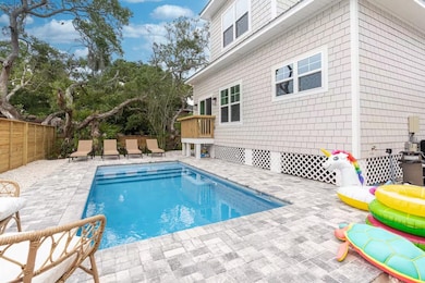 View of swimming pool featuring a patio area and a fenced backyard