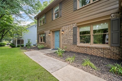 Entrance to property featuring brick siding and a yard