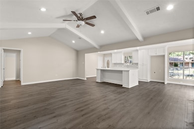 The open concept living room, kitchen, and breakfa