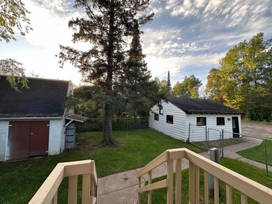 In between garage, shed, and house.