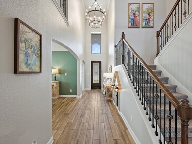 Upon Entry, you're greeted with soaring ceilings, added chandelier and much natural lighting all the way to the back of the home!