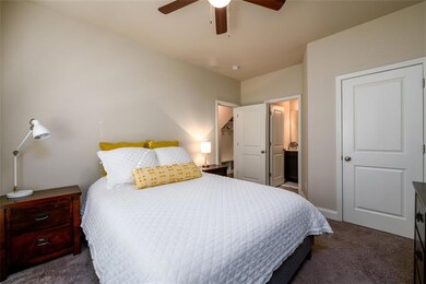 Bedroom featuring connected bathroom, baseboards, 