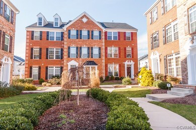 FRONT EXTERIOR, END UNIT, LANDSCAPED COURTYARD
