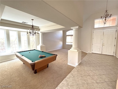 Recreation room featuring decorative columns, a ch
