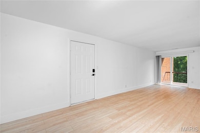 Unfurnished room with baseboards and light wood-type flooring