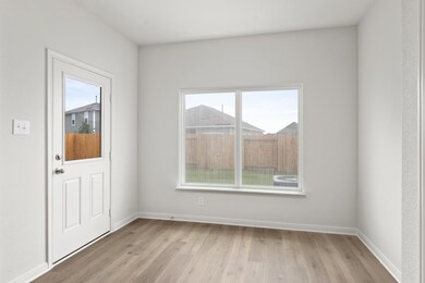Foyer entrance featuring light wood-style floors and baseboards
