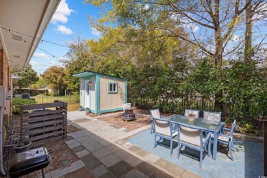 Backyard features a paver patio with an outdoor ta