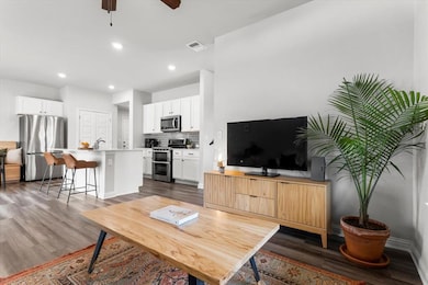 Living area featuring dark wood-style floors, a c