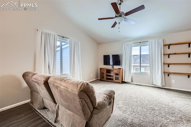 Living area with lofted ceiling, ceiling fan, and 