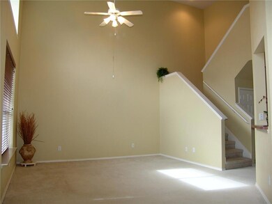 Living room has two story ceilings, window treatme