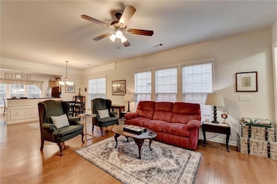 Living area featuring ceiling fan with notable cha