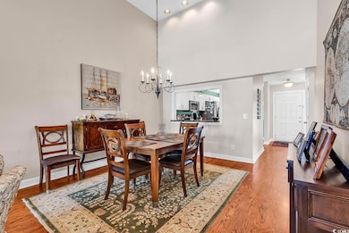 Dining room featuring a high ceiling, a chandelier