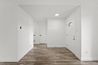 Entryway with hardwood / wood-style floors