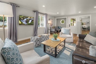 View of living room back toward front door and dining area.