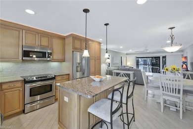 Kitchen featuring decorative backsplash, light sto