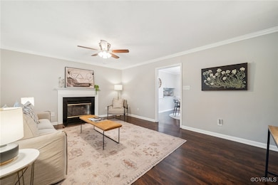 Living room with a ceiling fan, ornamental molding