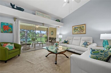 Carpeted living area with ceiling fan and high vaulted ceiling