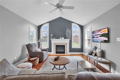 Living room with gas fireplace, ceiling fan and va