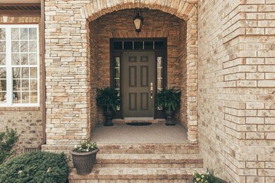 Stacked stone arch greets your guest on the front porch.