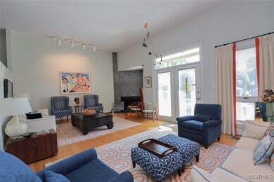 Living room with light wood-type flooring, a firep