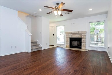 Unfurnished living room with ceiling fan, wood fi