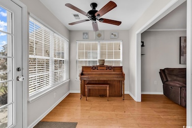 Living area with visible vents, baseboards, light 