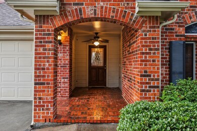 Charming red brick entryway with an arched design
