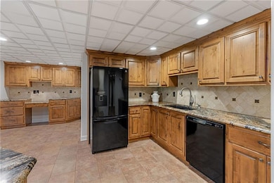 Second full kitchen on terrace level with double oven, cooktop, quartz counters, pantry, bar, and more!