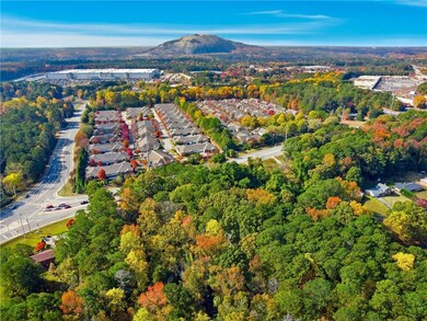 Aerial view of property and surrounding area with mountains and a heavily wooded area