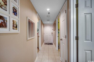 Hall with light tile patterned floors, a textured 