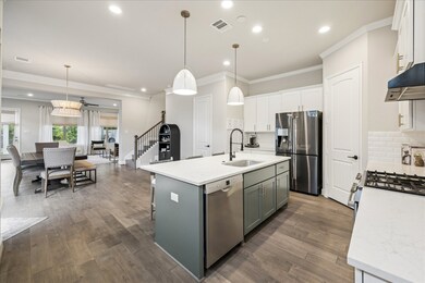 Open floor plan with living, dining, kitchen, and a half bathroom downstairs.