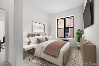 Bedroom with light wood-style floors and baseboards