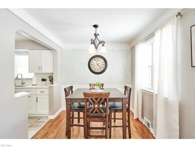 The dining area also has hardwood floors and the wall has been opened up into the newly remodeled kitchen